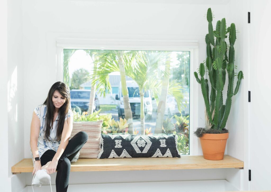 Cozy window seat with large picture window from Wallaby Windows, offering bright natural light, outdoor views, and enhanced home comfort