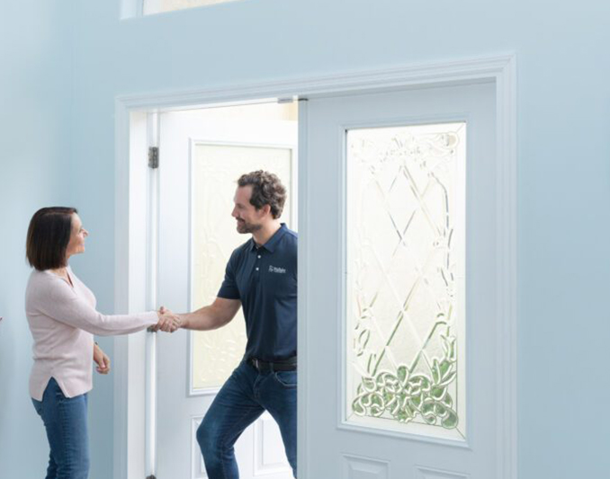 Wallaby Windows team member greeting homeowner at the front door, showcasing professional installation service and customer-first experience