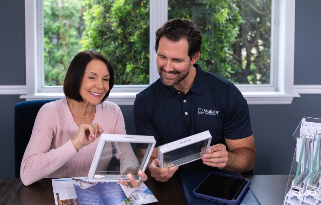 Wallaby Windows specialist reviewing energy-efficient glass samples with homeowner to help choose the best window replacement solution