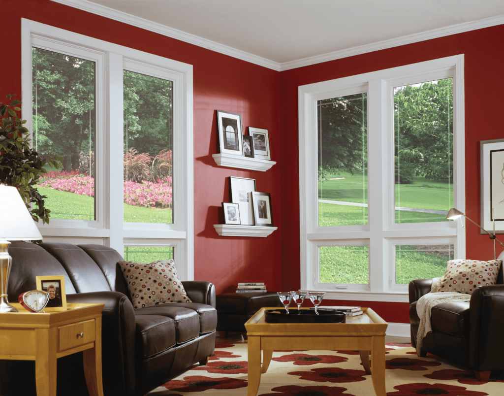Wallaby Windows double-hung windows in bright red living room with wide outdoor garden views