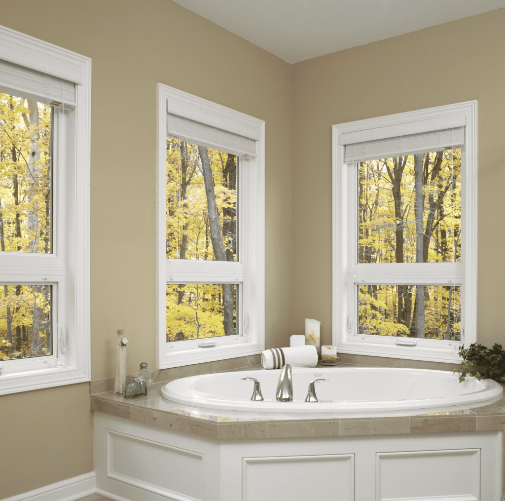 Wallaby Windows double-hung windows in bathroom providing natural light and wooded outdoor views