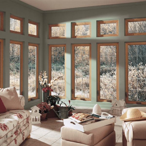 Wallaby Windows casement windows in sunroom with wood frames and expansive outdoor scenery