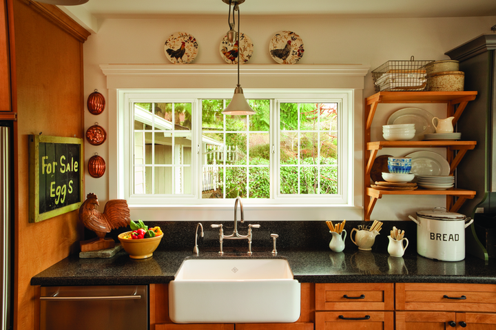 Cozy kitchen with wide replacement window above sink, offering natural light and improved energy efficiency