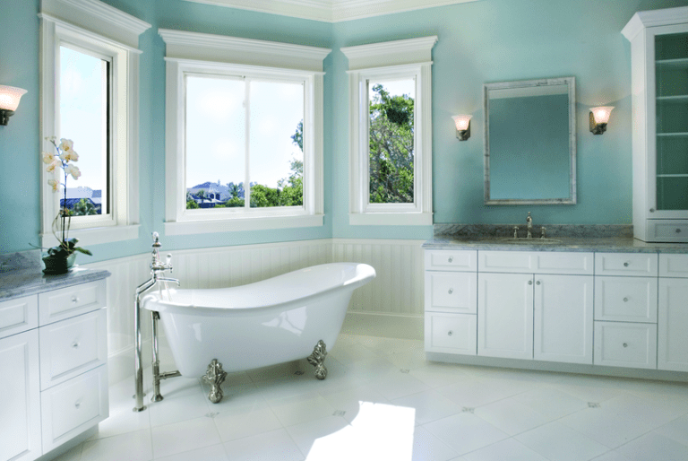 Spacious bathroom with large energy-efficient windows providing natural light, ventilation, and scenic outdoor views