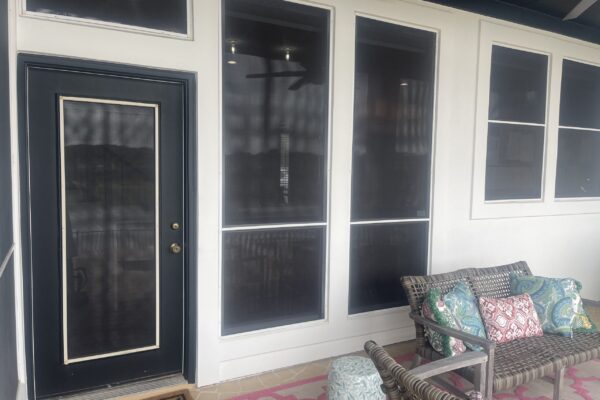 Before photo of screened porch with dark mesh window panels and door prior to window and enclosure upgrade by Wallaby Windows