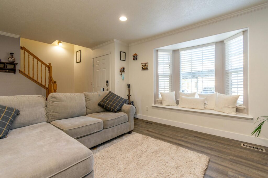 Double-hung bay window with interior seating nook in living room