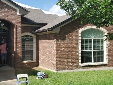 Before and after arched window replacement showcasing upgraded energy-efficient windows on brick home exterior