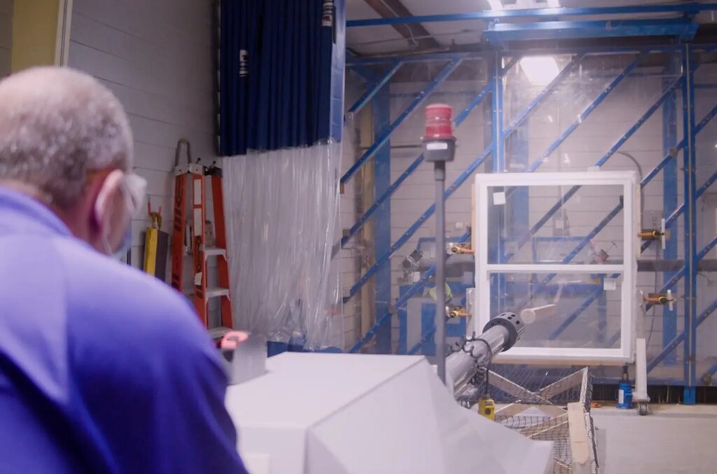 Impact-resistant window undergoing storm testing to ensure coastal durability and protection against high winds and flying debris