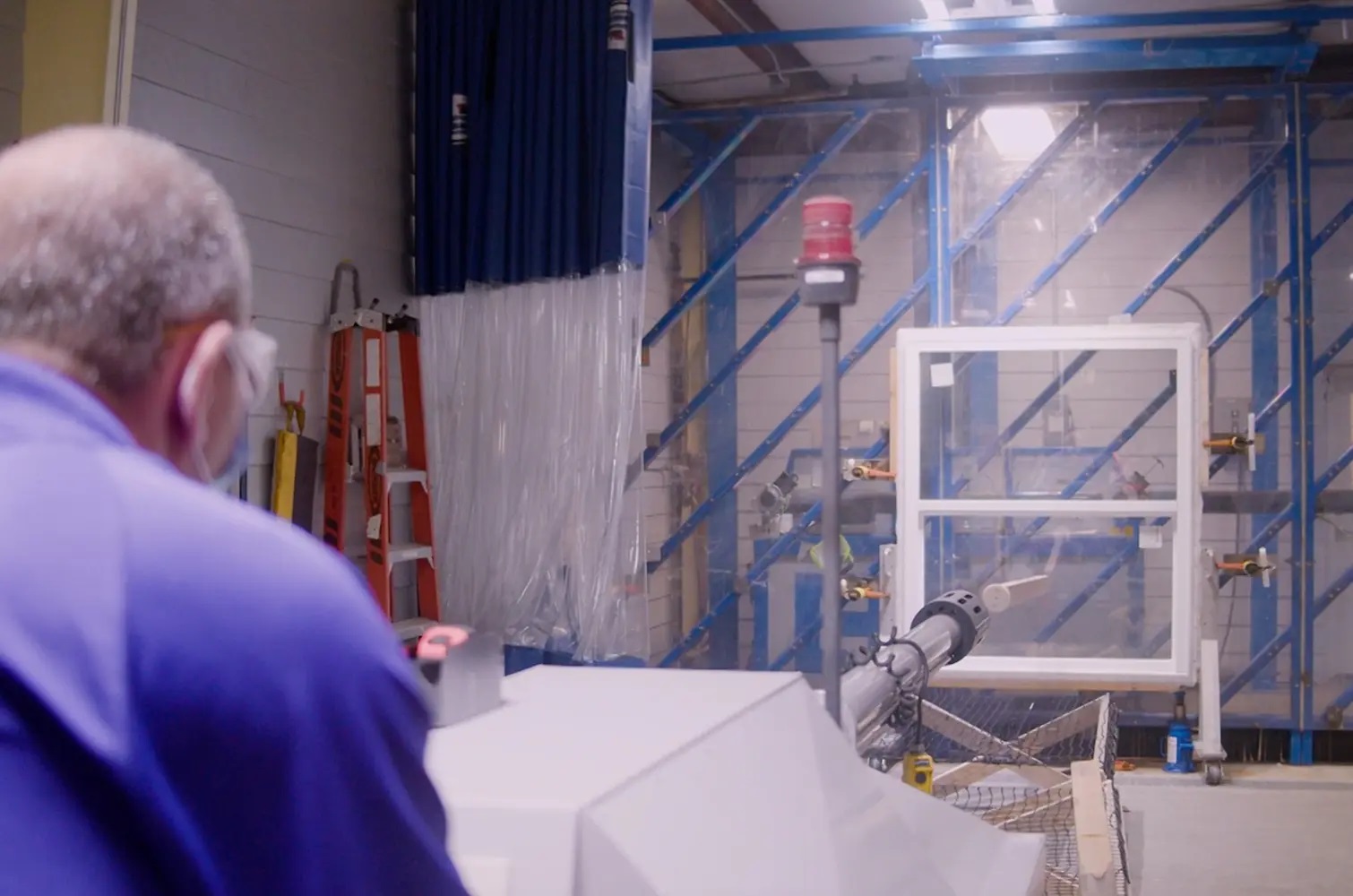 Impact-resistant window undergoing storm testing to ensure coastal durability and protection against high winds and flying debris