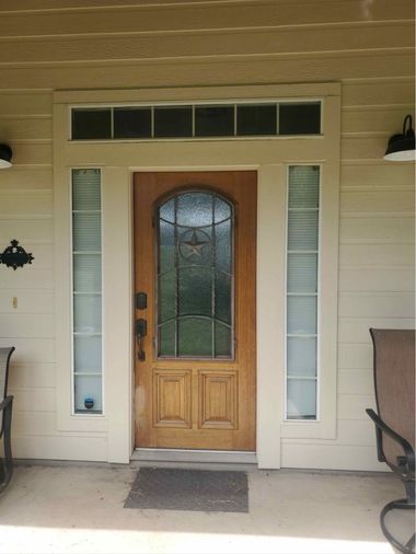 Before photo of front entry door with sidelights and transom window prior to replacement by Wallaby Windows, showing outdated design and limited energy efficiency