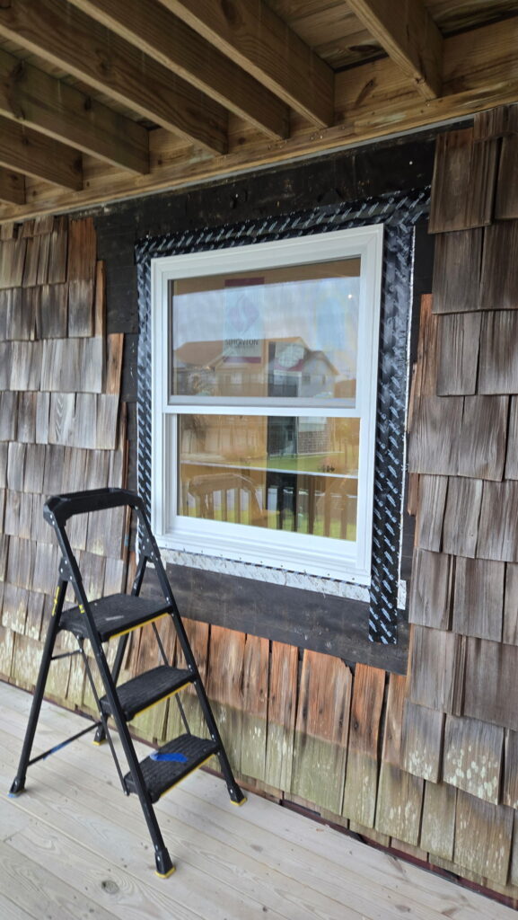 Wallaby Windows professional installing a coastal-rated energy-efficient window with proper flashing and sealing for long-term weather protection