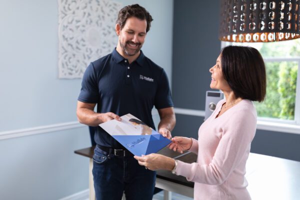 Wallaby representative providing a product brochure to a homeowner