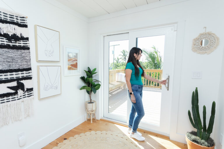 Homeowner opening newly installed glass patio door