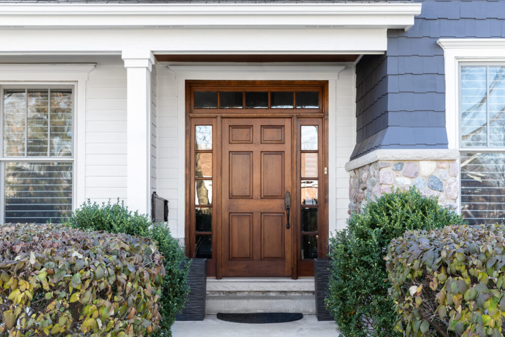 Custom wooden front door with decorative glass panels and side windows