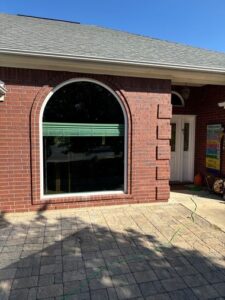 Brick exterior with updated arched geometric window installation