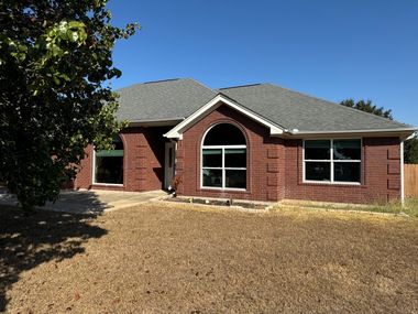 Brick house exterior with large arched geometric windows
