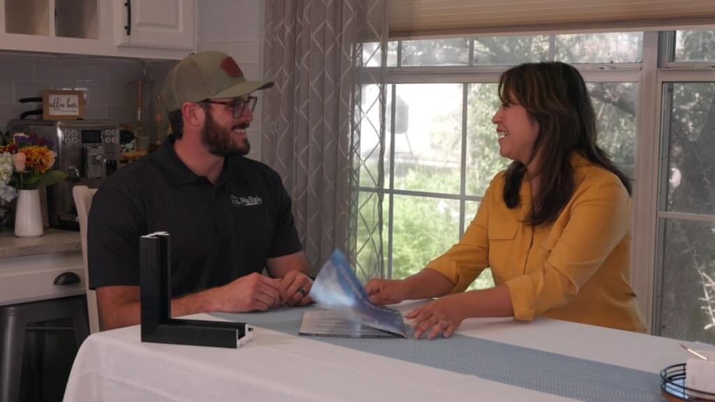 Homeowner reviewing product brochure with Wallaby Windows consultant